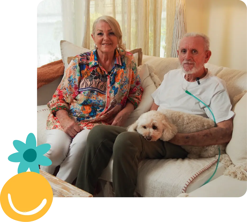 Older couple with a dog on a couch