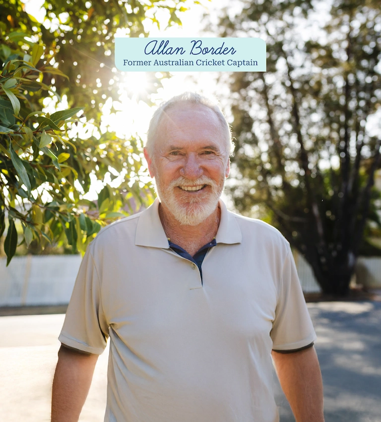 Allan Border, former Australian cricket captain, smiling in his backyard